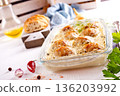 Italian casserole of baked meatballs in spicy white sauce with mozzarella cheese 136203992