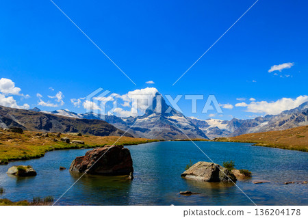View of Stelli Lake (Stellisee) and Matterhorn mountain at summer in Zermatt, Swiss Alps, Switzerland 136204178