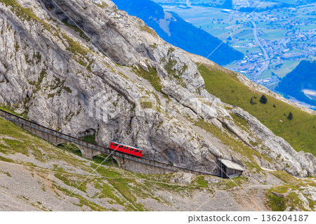 Cogwheel train climbing to the top of Mount Pilatus in Canton Lucerne, Switzerland. World's steepest cogwheel railway Cogwheel train climbing to the top of Mount Pilatus in Canton Lucerne, Switzerland. World's steepest cogwheel railway 136204187