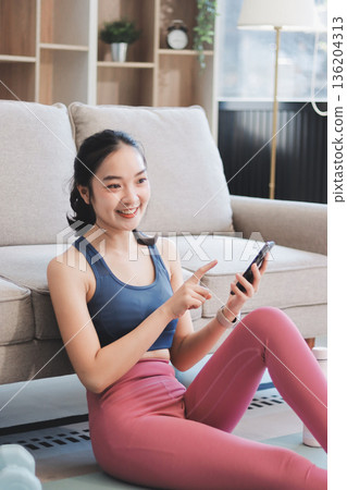 Young Asian sporty attractive people practicing yoga lesson with instructor. Asia group of women exercising healthy lifestyle in fitness studio. Sport activity, gymnastics or ballet dancing class. 136204313