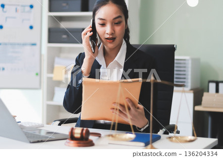 Lawyer explained to the client about the law that must be brought against the court case. Lawyer explained to the client about the law that must be brought against the court case. 136204334