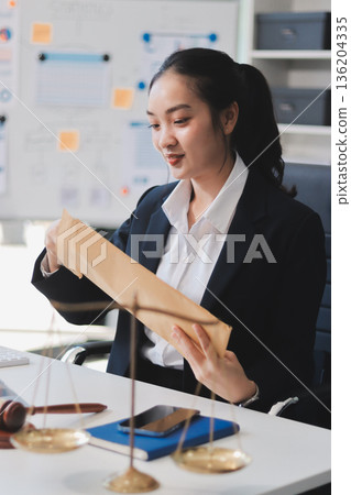 Lawyer explained to the client about the law that must be brought against the court case. Lawyer explained to the client about the law that must be brought against the court case. 136204335