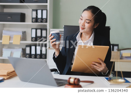 Lawyer explained to the client about the law that must be brought against the court case. Lawyer explained to the client about the law that must be brought against the court case. 136204340