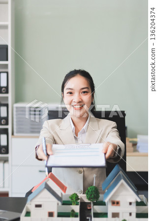real estate agent home miniature model on documents sale and purchase of apartment notarial deed 136204374