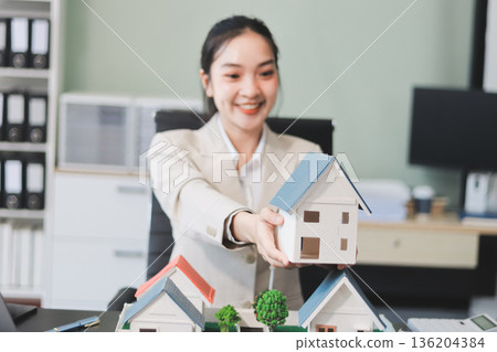 real estate agent home miniature model on documents sale and purchase of apartment notarial deed 136204384