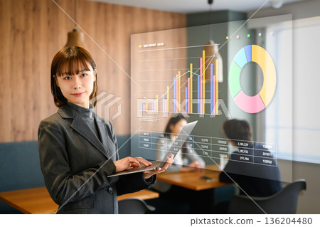 Female employee with a laptop Female employee with a laptop 136204480