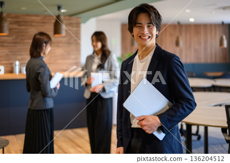 Smiling businessman and office 136204512