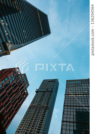 tall skyscrapers buildings looking up perspective, downtown district modern architecture of steel and glass, skyline of big city, low angle look-up view tall skyscrapers buildings looking up perspective, downtown district modern architecture of steel and glass, skyline of big city, low angle look-up view 136204564