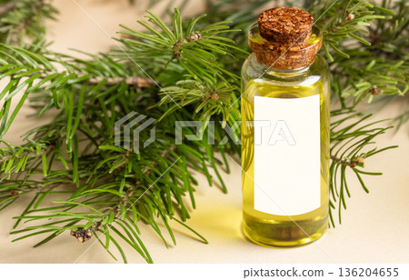 Abies fir essential oil bottle with cork stopper and evergreen branches Abies fir essential oil bottle with cork stopper and evergreen branches 136204655