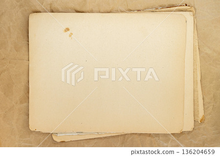 Vintage blanks paper sheets with stains on wrinkled kraft background. Concept of aged paper texture, retro mockup or nostalgic layout, copy space 136204659