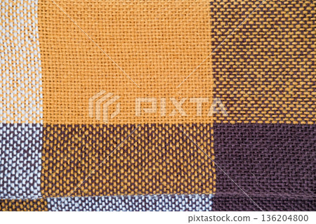 Brown plaid scarf on a light background Brown plaid scarf on a light background 136204800