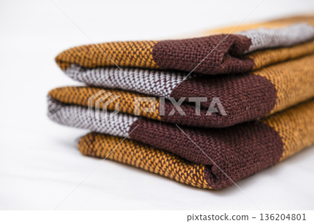 Brown plaid scarf on a light background Brown plaid scarf on a light background 136204801