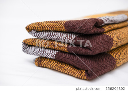 Brown plaid scarf on a light background 136204802