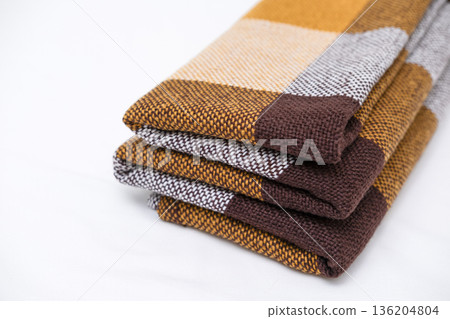 Brown plaid scarf on a light background Brown plaid scarf on a light background 136204804