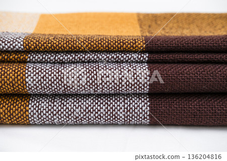 Brown plaid scarf on a light background 136204816