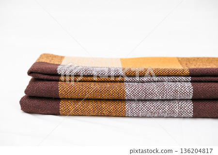 Brown plaid scarf on a light background Brown plaid scarf on a light background 136204817
