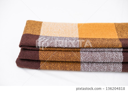 Brown plaid scarf on a light background 136204818