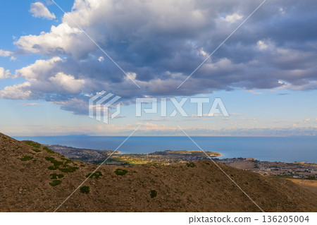 Dramatic aerial view of coastal town Cholpon-Ata and and mountains at sunset 136205004