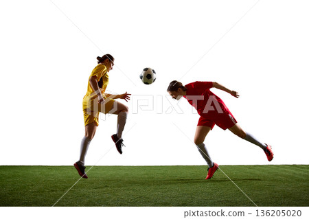 Female soccer players aerial duel with knee trap and diving header. Female soccer players aerial duel with knee trap and diving header. 136205020