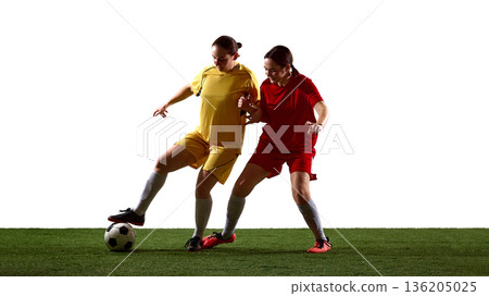 Female soccer players in close contact duel controlling ball on white background. 136205025