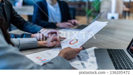 Reviewing materials at a meeting Reviewing materials at a meeting 136205472