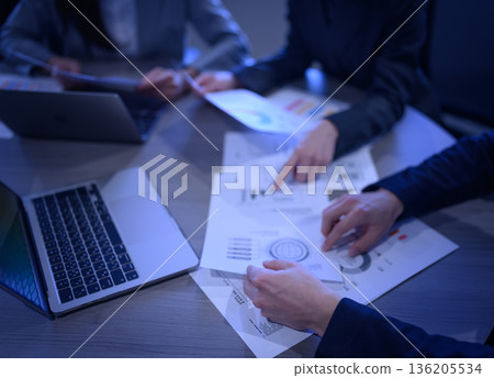 Reviewing materials at a meeting 136205534