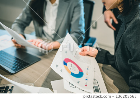 Checking materials at a meeting Checking materials at a meeting 136205565