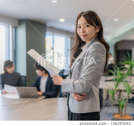 Businesswoman with document Businesswoman with document 136205643