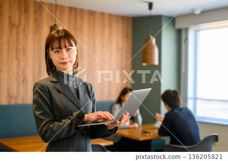 Business woman with a laptop Business woman with a laptop 136205821