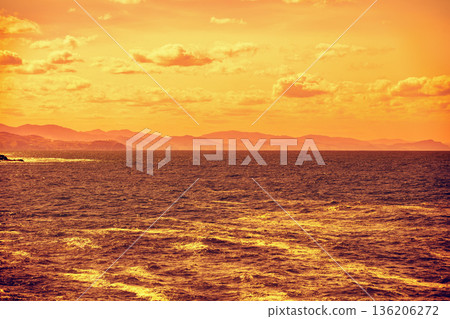 Cloudy sky over the sea at golden sunset. Abstract nature background. Donostia, San Sebastian, Basque Country, Spain 136206272