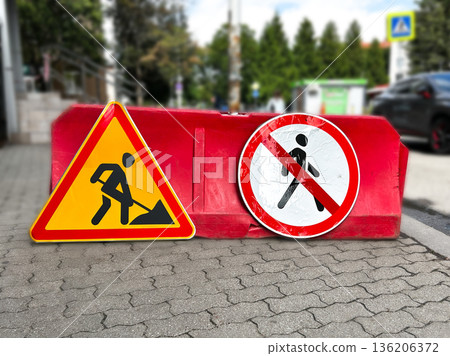Warning traffic sign of construction works are happening. Yellow triangle symbol of working man. Restriction sign of safety zone 136206372