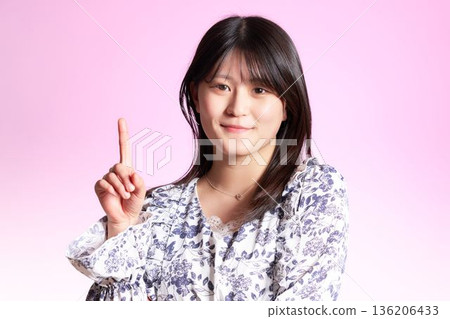 A smiling Japanese woman highlighting her points A smiling Japanese woman highlighting her points 136206433