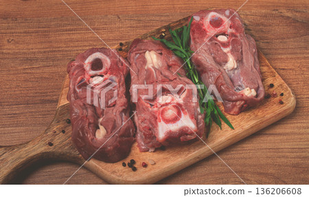 raw steak, calf's neck on the bone, fresh meat, on the cutting board, top view, no people, 136206608
