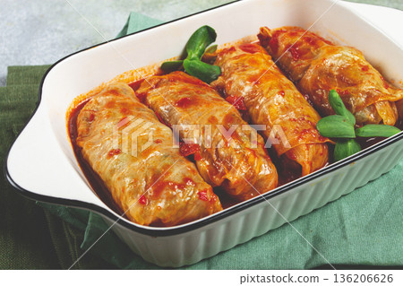 Stuffed cabbage rolls with minced meat, in tomato sauce, top view, without people, in the spotlight. Stuffed cabbage rolls with minced meat, in tomato sauce, top view, without people, in the spotlight. 136206626