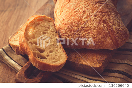 sliced ciabatta , on a chopping board, italian bread, close-up, Italian cuisine, breakfast, no people, sliced ciabatta , on a chopping board, italian bread, close-up, Italian cuisine, breakfast, no people, 136206640