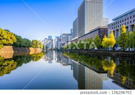 The moat of the Imperial Palace and the skyscrapers of Marunouchi and Otemachi reflected on the water 136206701
