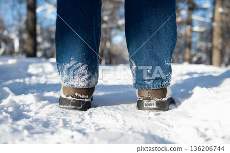 Winter boots walking in snow close up 136206744