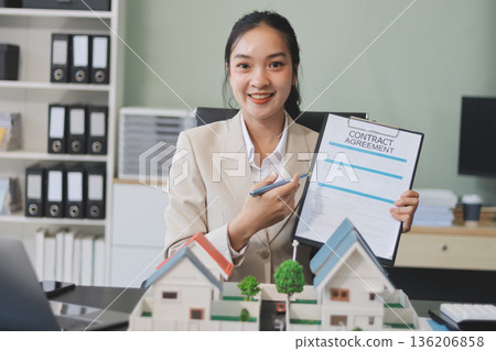 real estate agent home miniature model on documents sale and purchase of apartment notarial deed 136206858