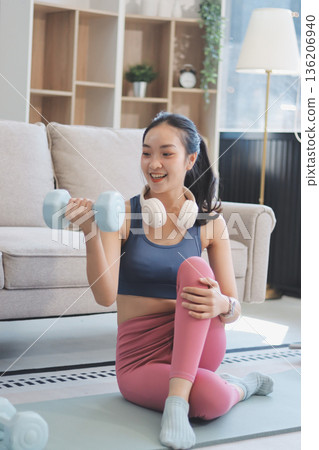 Young Asian sporty attractive people practicing yoga lesson with instructor. Asia group of women exercising healthy lifestyle in fitness studio. Sport activity, gymnastics or ballet dancing class. 136206940