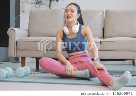 Young Asian sporty attractive people practicing yoga lesson with instructor. Asia group of women exercising healthy lifestyle in fitness studio. Sport activity, gymnastics or ballet dancing class. Young Asian sporty attractive people practicing yoga lesson with instructor. Asia group of women exercising healthy lifestyle in fitness studio. Sport activity, gymnastics or ballet dancing class. 136206941