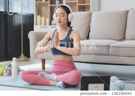 Young Asian sporty attractive people practicing yoga lesson with instructor. Asia group of women exercising healthy lifestyle in fitness studio. Sport activity, gymnastics or ballet dancing class. Young Asian sporty attractive people practicing yoga lesson with instructor. Asia group of women exercising healthy lifestyle in fitness studio. Sport activity, gymnastics or ballet dancing class. 136206943