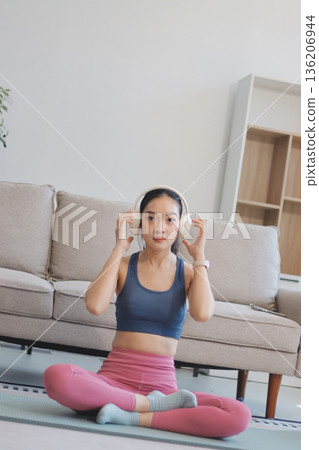 Young Asian sporty attractive people practicing yoga lesson with instructor. Asia group of women exercising healthy lifestyle in fitness studio. Sport activity, gymnastics or ballet dancing class. Young Asian sporty attractive people practicing yoga lesson with instructor. Asia group of women exercising healthy lifestyle in fitness studio. Sport activity, gymnastics or ballet dancing class. 136206944