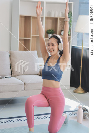Young Asian sporty attractive people practicing yoga lesson with instructor. Asia group of women exercising healthy lifestyle in fitness studio. Sport activity, gymnastics or ballet dancing class. Young Asian sporty attractive people practicing yoga lesson with instructor. Asia group of women exercising healthy lifestyle in fitness studio. Sport activity, gymnastics or ballet dancing class. 136206945