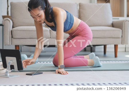 Young Asian sporty attractive people practicing yoga lesson with instructor. Asia group of women exercising healthy lifestyle in fitness studio. Sport activity, gymnastics or ballet dancing class. Young Asian sporty attractive people practicing yoga lesson with instructor. Asia group of women exercising healthy lifestyle in fitness studio. Sport activity, gymnastics or ballet dancing class. 136206949