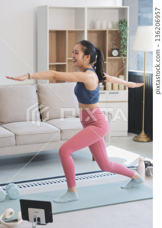 Young Asian sporty attractive people practicing yoga lesson with instructor. Asia group of women exercising healthy lifestyle in fitness studio. Sport activity, gymnastics or ballet dancing class. Young Asian sporty attractive people practicing yoga lesson with instructor. Asia group of women exercising healthy lifestyle in fitness studio. Sport activity, gymnastics or ballet dancing class. 136206957