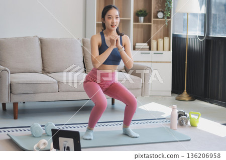Young Asian sporty attractive people practicing yoga lesson with instructor. Asia group of women exercising healthy lifestyle in fitness studio. Sport activity, gymnastics or ballet dancing class. Young Asian sporty attractive people practicing yoga lesson with instructor. Asia group of women exercising healthy lifestyle in fitness studio. Sport activity, gymnastics or ballet dancing class. 136206958