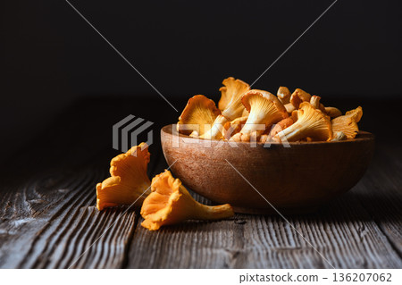 Chanterelles arranged on aged wooden surface in natural light Chanterelles arranged on aged wooden surface in natural light 136207062