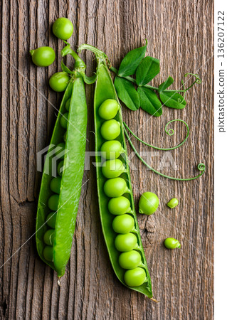 Fresh green peas in pods on wooden table background Fresh green peas in pods on wooden table background 136207122
