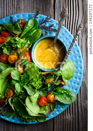 Mixed salad greens with cherry tomatoes and honey mustard dressing Mixed salad greens with cherry tomatoes and honey mustard dressing 136207172