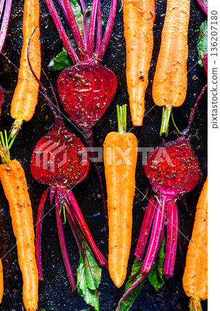 Raw beetroot and carrots with spices on dark surface Raw beetroot and carrots with spices on dark surface 136207180